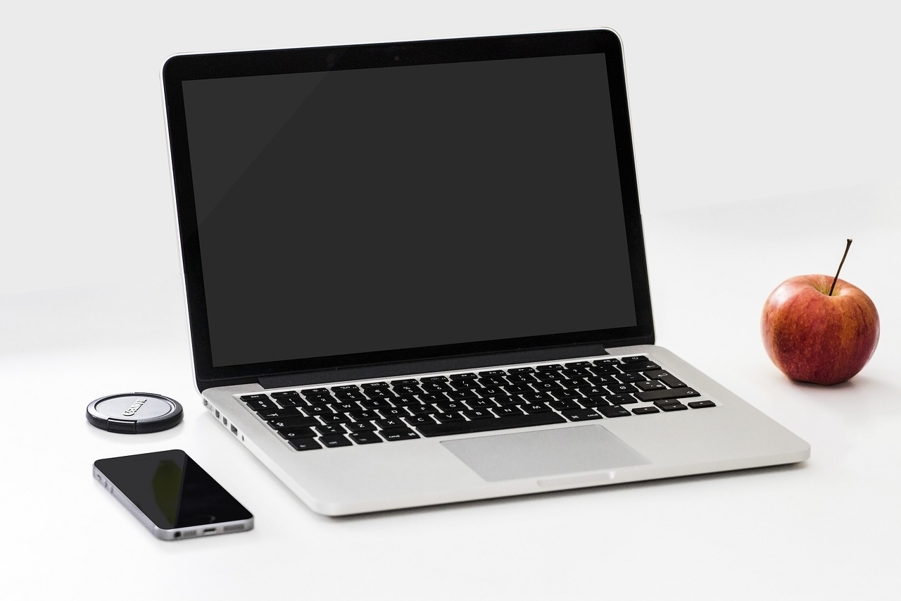 Desk setup with laptop and phone for focused coding session